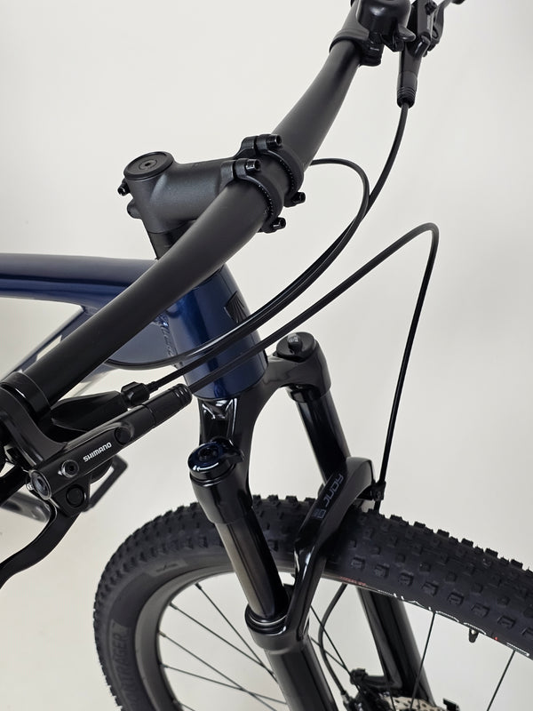 Trek X-CALIBER 7 with close-up of the suspension and travel mechanics of the RockShox Judy SL.