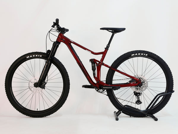 Side angle image of the Merida One-Twenty 600 29 2023 Full Suspension Mountain Bike, highlighting its sleek design and red frame.