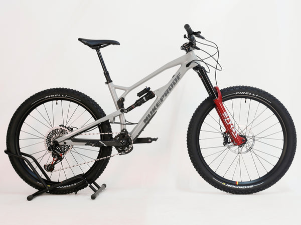 Nukeproof Mega 275 RS X01 Eagle CARBON bike showing off the sleek design and red RockShox components, perfect for enduro riders.