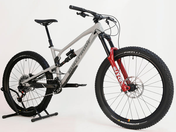 Nukeproof Mega 275 RS X01 Eagle CARBON bike with a close-up view of the suspension, showcasing the bike's advanced shock technology.