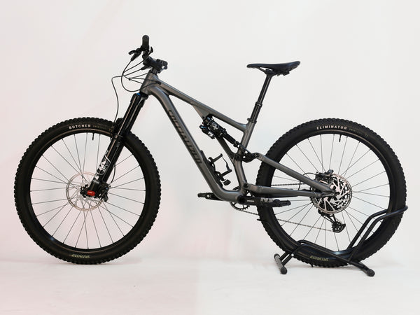 Rear view of Specialized Stumpjumper EVO Comp Alloy 29 Medium S3 mountain bike, displaying suspension and tire.