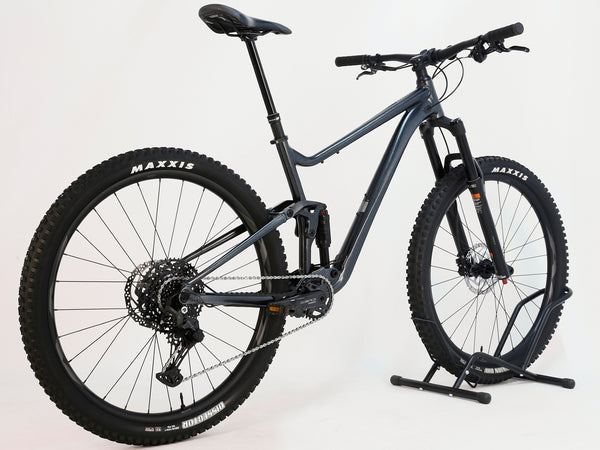 Side view of Giant Stance 29 2 2024/LARGE mountain bike, showcasing its full suspension system and sturdy alloy frame.