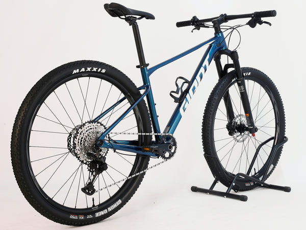 Giant XTC SLR 29 1 2024 in Excellent Condition at eMado Bikes - close-up of the Shimano SLX M-7100 shifters and handlebars.