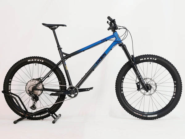 Detailed view of the handlebars of the Used Ragley Blue Pig Race 2022 mountain bike, showcasing the upgraded Burgtec components. Find it at eMado Bikes.