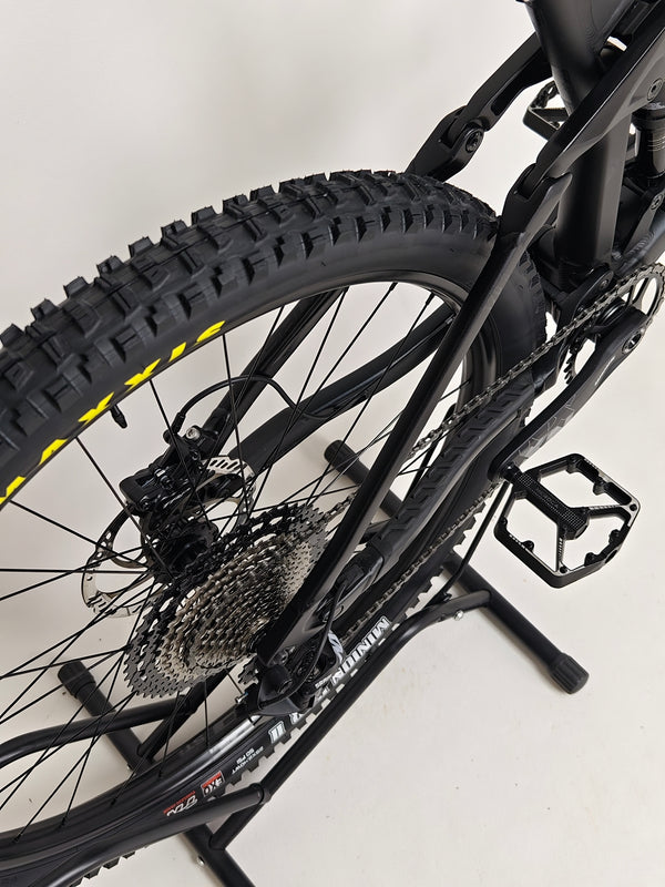 Full view of the Cube Stereo 170 SL 29 mountain bike 2021 with rider on it.