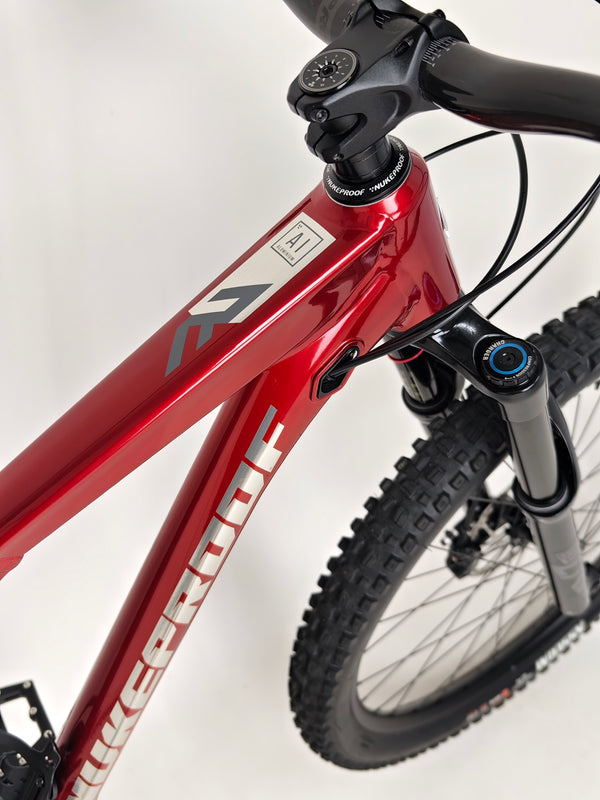 Detailed imagery showing the headset and front suspension of the Nukeproof Reactor 290 PRO 2023 at eMado Bikes.