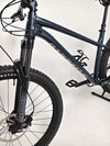 Close-up shot of the front suspension on the Specialized Fuse Sport 27.5 2024 in Excellent Condition at eMado Bikes, featuring the disc brake setup.