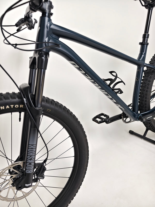 Close-up shot of the front suspension on the Specialized Fuse Sport 27.5 2024 in Excellent Condition at eMado Bikes, featuring the disc brake setup.