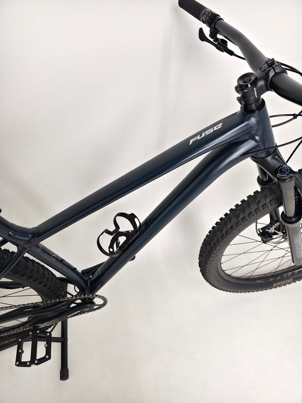 View of the bike’s rear wheel and tire on Specialized Fuse Sport 27.5 2024 in Excellent Condition at eMado Bikes.