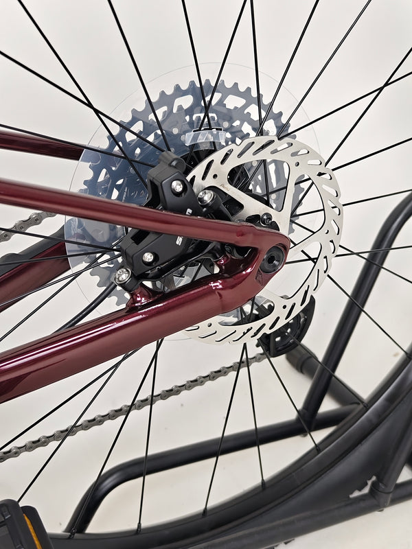 Angle view of the bike's side showing the striking red finish of the Specialized Chisel 2025 Never Used Bike.