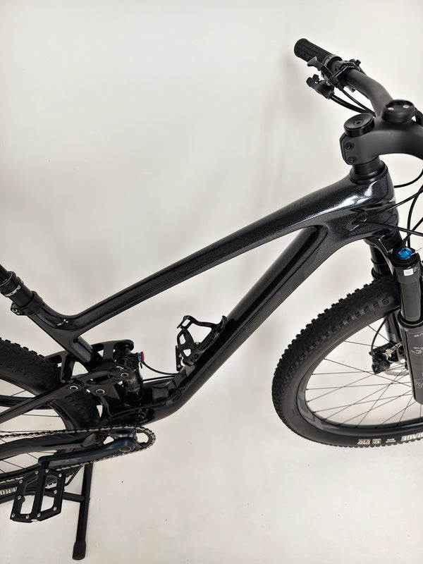 Giant Anthem Advanced Pro 29 2 2023 CARBON bike on a trail in an outdoor adventure setting.