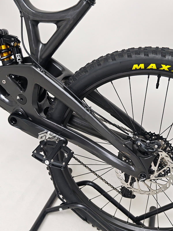 Evil Insurgent LS 27.5 Carbon bike captured in natural sunlight against a vibrant background.