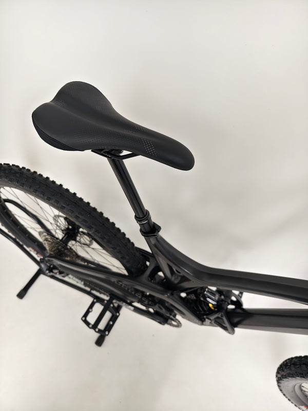 Evil Insurgent LS 27.5 Carbon bike next to the tools, emphasizing its custom-built quality.