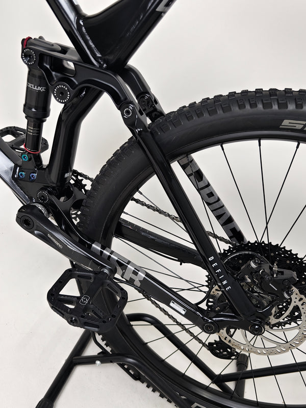 NS Bikes Define AL 130 2 2023 - Detailed view of the bike's mechanics focusing on the front fork and brake details from NS Bikes.