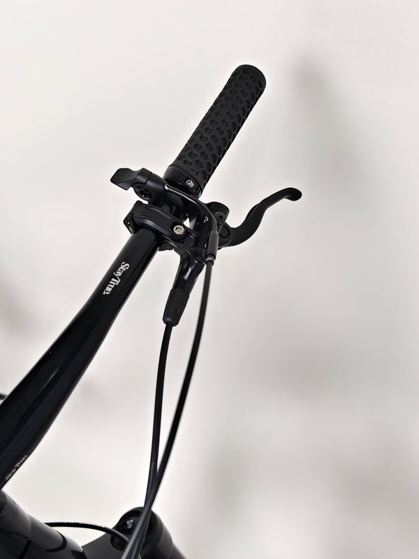 NS Bikes Define AL 130 2 2023 - Focused view of the handlebars and brake levers showcasing the bike's performance design from NS Bikes.