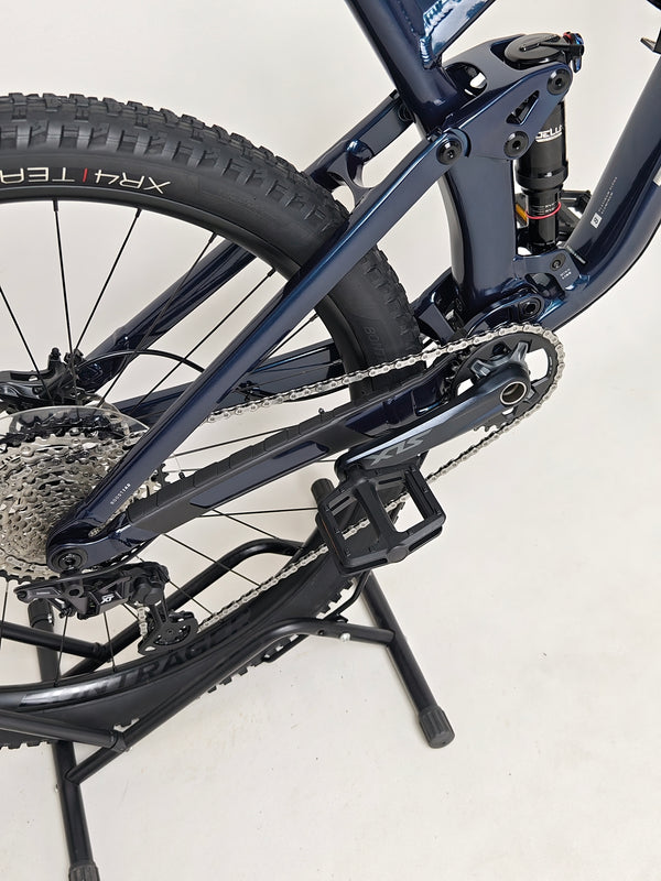 Trek Top Fuel 8 2024 Large Frame Full Suspension Bike at eMado - Angle view showing the suspension setup and bike height.