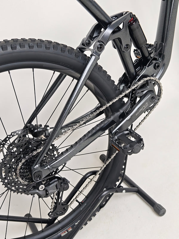 Detailed close-up of rear tire and rim assembly on Giant Stance 29 2 2024/LARGE.