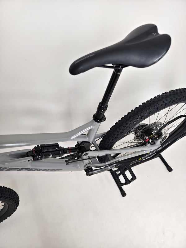 Tight view of the front suspension fork and brake rotor of the Nukeproof Mega 275 RS X01 Eagle bike.