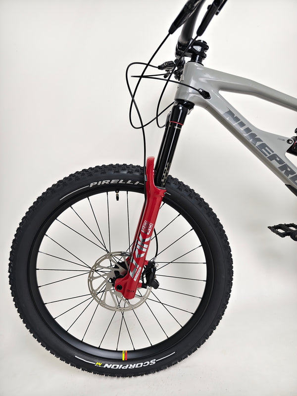 Detailed view of the rear derailleur system on the Nukeproof Mega 275 RS X01 Eagle bike, showcasing its quality components.