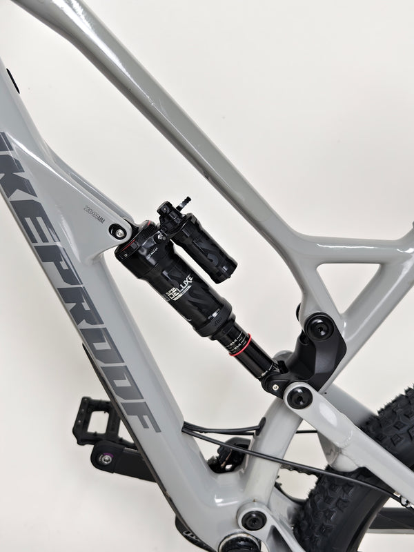 Rear suspension detail of the Nukeproof Mega 275 RS X01 Eagle bike, showcasing the custom RockShox Super Deluxe shock.