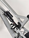 Close-up of Nukeproof Mega 275 RS X01 Eagle bike's red RockShox component and disc brake.