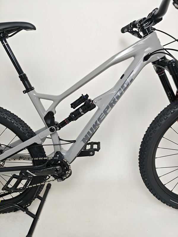 Close-up of the handlebar controls on the Nukeproof Mega 275 RS X01 Eagle bike, highlighting SRAM brake levers.