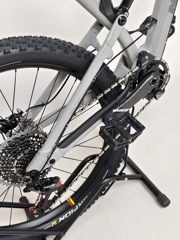 Detail shot of the rear wheel of Nukeproof Mega 275 RS X01 Eagle bike showcasing tire and hub.