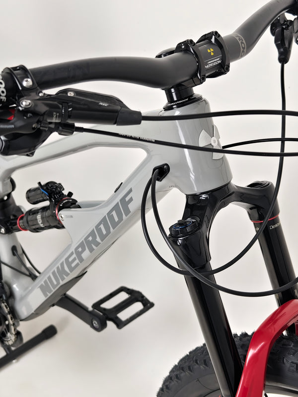 Nukeproof Mega 275 RS X01 Eagle bike showcasing the advanced braking system and rotor configuration.