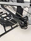 Detailed view of the rear triangle of the Nukeproof Mega 275 RS X01 Eagle bike, focusing on suspension and materials.