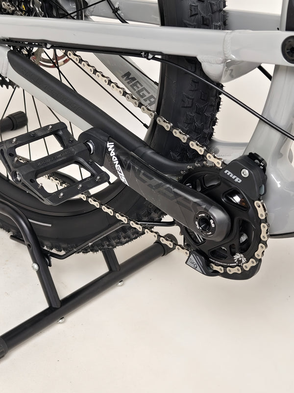 Detailed view of the rear triangle of the Nukeproof Mega 275 RS X01 Eagle bike, focusing on suspension and materials.