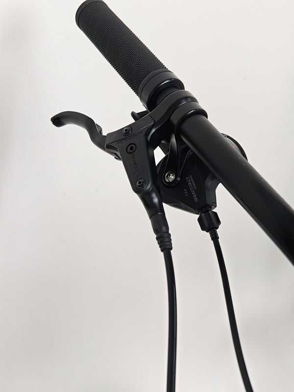 Rear view of the Rocky Mountain Instinct Alloy 10 2023, depicting its stylish rear design and wheel setup, available at eMado Bikes.