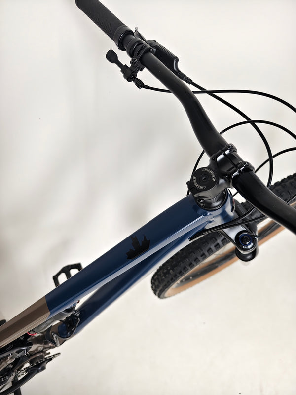 Close-up of the rear wheel of Rocky Mountain Instinct Alloy 10 2023, highlighting the Butcher Gridtrail tubeless tyres, available at eMado Bikes.