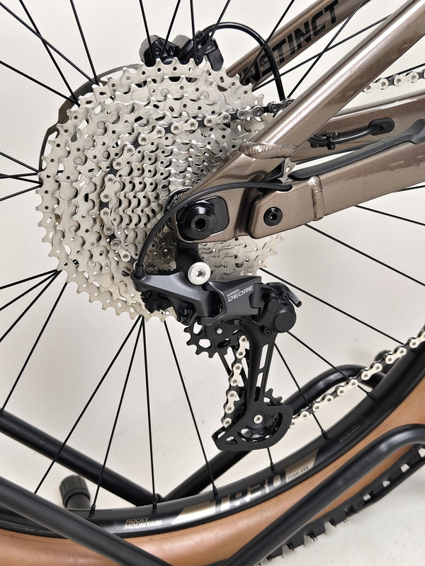 Close-up view of the front brakes on the Rocky Mountain Instinct Alloy 10 2023, emphasizing its stopping power design, available at eMado Bikes.