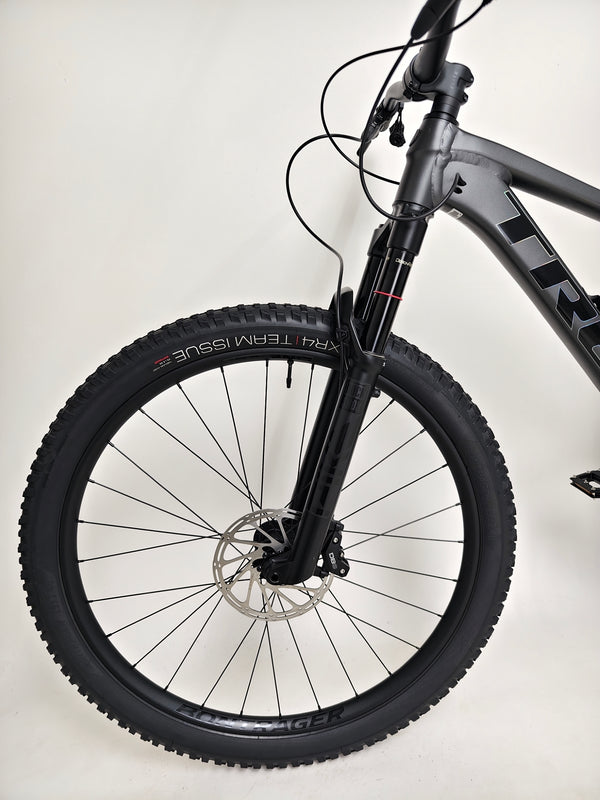 Trek Top Fuel 8 GX AXS 2024 LARGE Frame in Excellent Condition at eMado Bikes displayed on a scenic mountain trail.