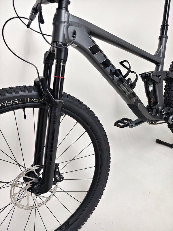 Action shot of Trek Top Fuel 8 GX AXS 2024 LARGE Frame in Excellent Condition at eMado Bikes, demonstrating its performance on rugged terrain.