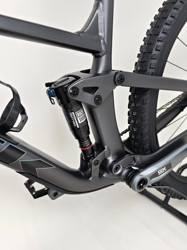 Trek Top Fuel 8 GX AXS 2024 LARGE Frame in Excellent Condition at eMado Bikes in a detailed shot showcasing its built quality.