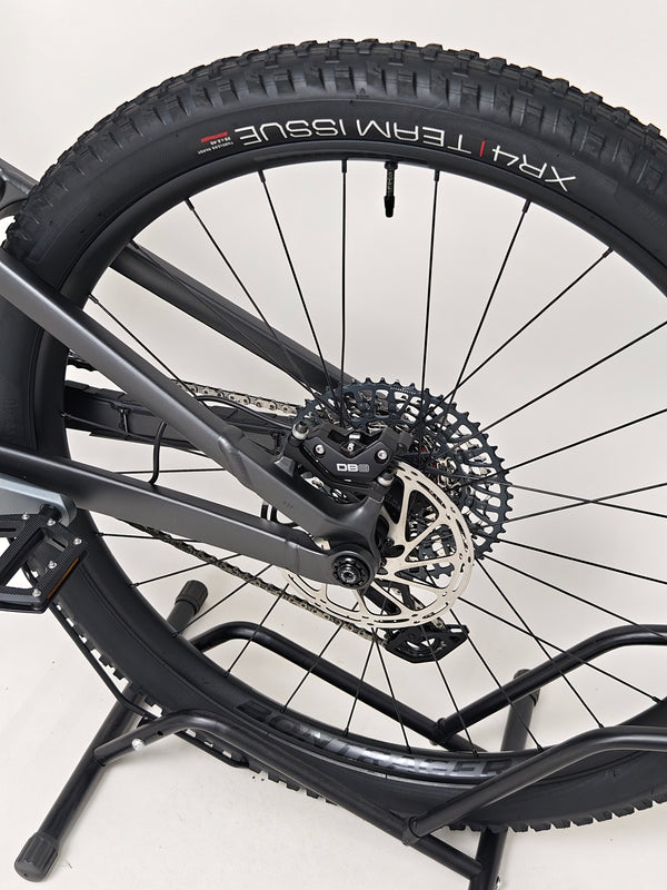 Trek Top Fuel 8 GX AXS 2024 LARGE Frame in Excellent Condition at eMado Bikes on display alongside various biking accessories.