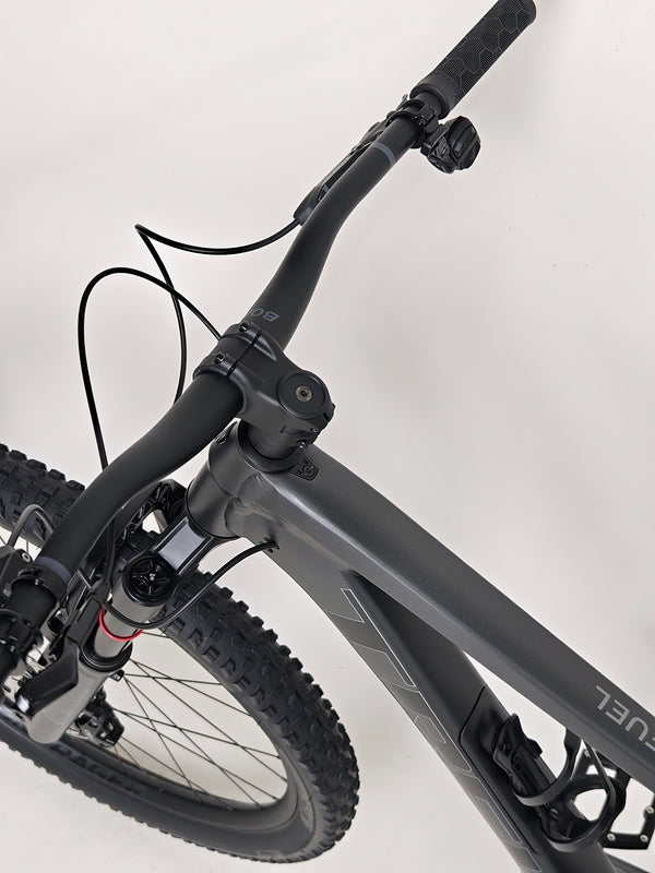 Trek Top Fuel 8 GX AXS 2024 LARGE Frame in Excellent Condition at eMado Bikes, presented with an adventurous mountain setting to demonstrate its capabilities.