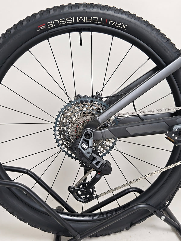 Trek Top Fuel 8 GX AXS 2024 LARGE Frame in Excellent Condition at eMado Bikes captured in a dynamic outdoor setting accentuating its durability.