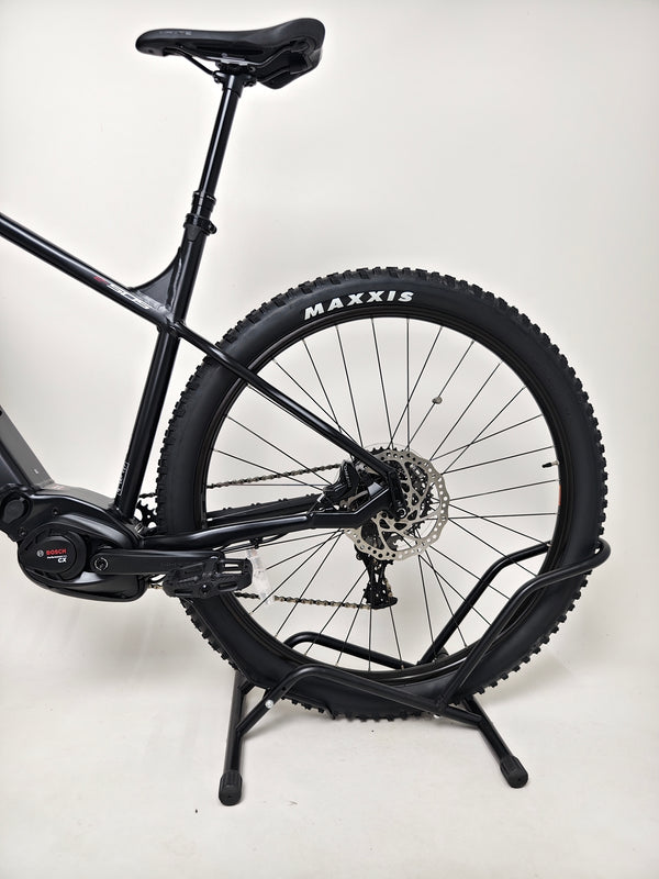 Whyte e-505 v1 Electric Bike 2024 in action on a trail, highlighting performance and low mileage.