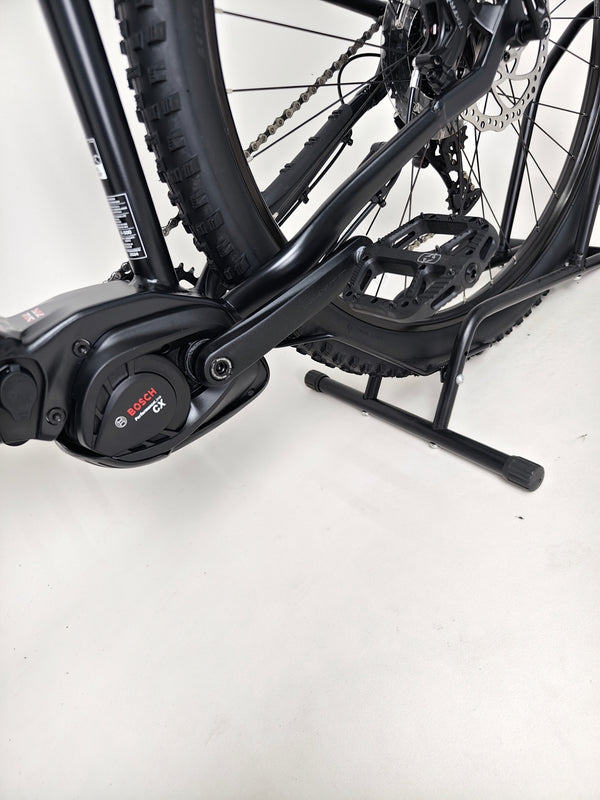 Close-up detail of the handlebars on the Whyte e-505 v1 Electric Bike 2024, showcasing quality grips and controls.