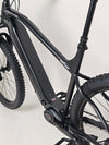 Rear view of the Whyte e-505 v1 Electric Bike 2024, highlighting the e-bike specific rear hub and 4-piston brakes.