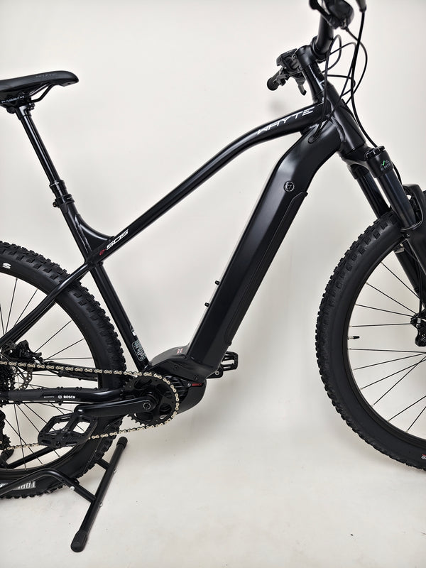 Whyte e-505 v1 Electric Bike 2024 positioned outdoors, showcasing its low mileage and like-new state.