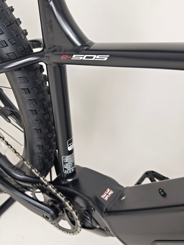 Action shot of the Whyte e-505 v1 Electric Bike 2024 in XL during an outdoor ride, showcasing its performance.