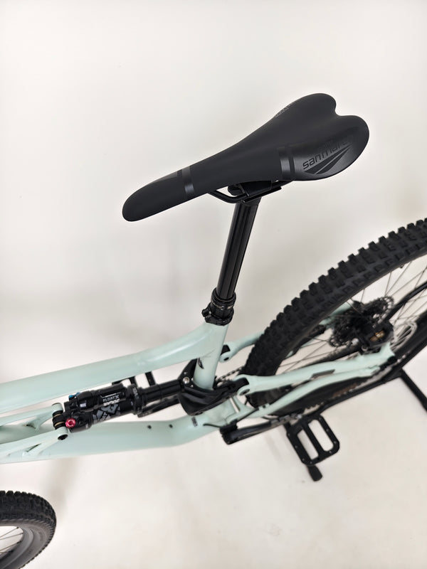 Specialized Status 160 in Very Good Condition at eMado Bikes - dynamic angle of the bike taken outdoors.