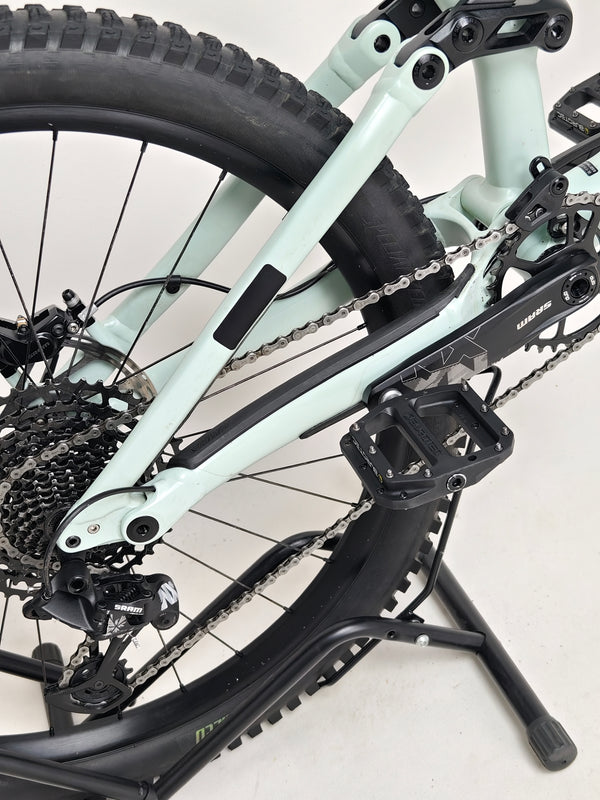 Specialized Status 160 in Very Good Condition at eMado Bikes - showcasing the bike in action on a rugged terrain.