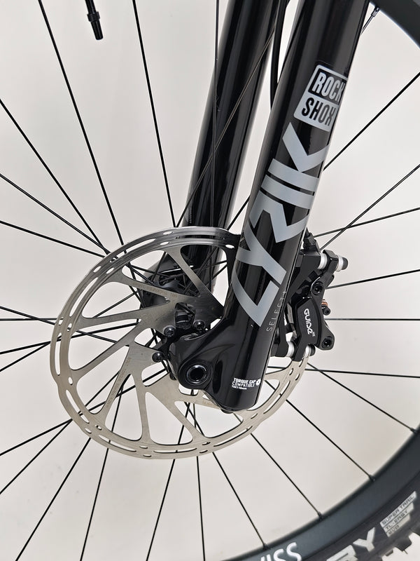 Dynamic background featuring Nukeproof Scout 275 RS 2023 in excellent used condition on the trails.