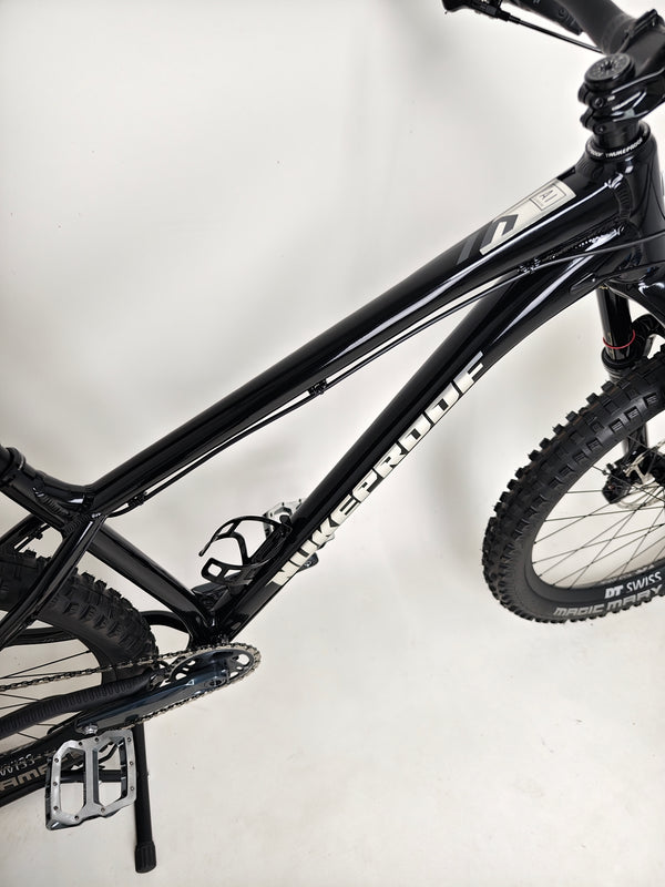 A stylized shot of Nukeproof Scout 275 RS 2023 in excellent used condition, ideal for mountain biking enthusiasts.