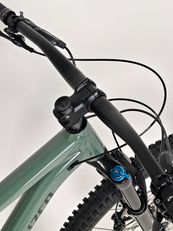 Angle view of the used Specialized Stumpjumper Comp Alloy with mountain biking gear.