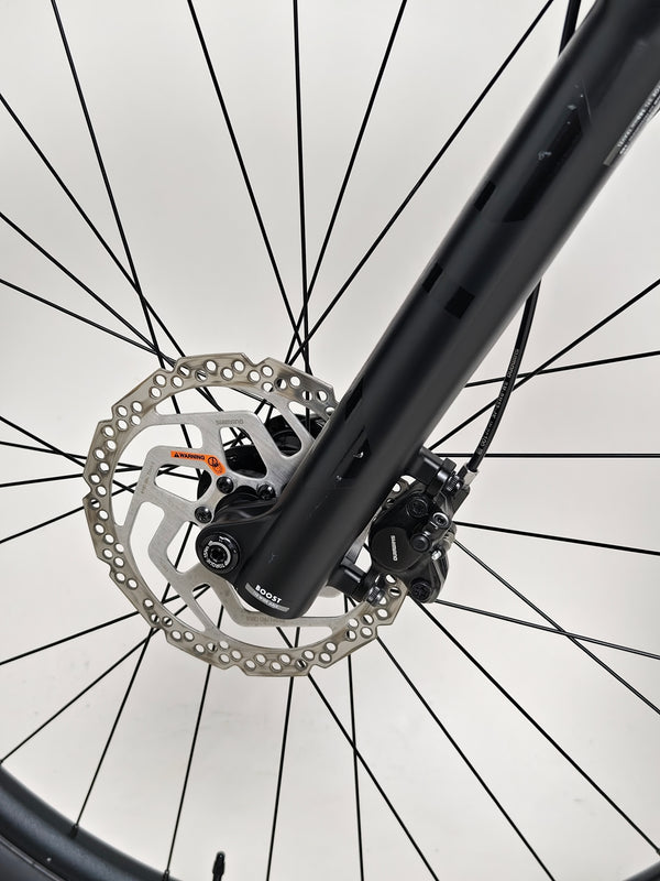 Close-up of the front fork on the Giant Stance 29 2 elucidating technical specs.